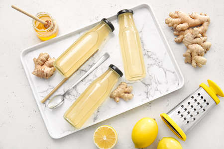 Composition with healthy ginger juice on light backgroundの写真素材