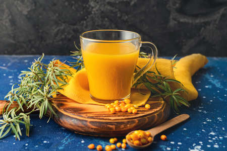 Cup of healthy sea buckthorn tea on tableの写真素材