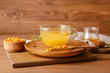 Cup of healthy sea buckthorn tea on tableの写真素材