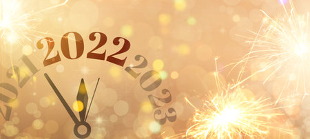 Clock with figures denoting different years on color background. New Year 2022 celebration