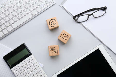 Cubes with digital technology icons, computer and calculator on light backgroundの写真素材