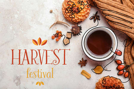 Beautiful autumn composition with cup of coffee and HARVEST FESTIVAL on light backgroundの写真素材