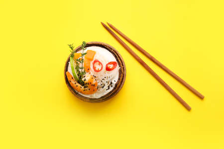 Bowl with Thai noodle soup on color backgroundの写真素材