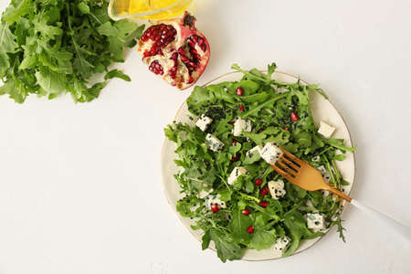 Plate with arugula salad on light backgroundの写真素材