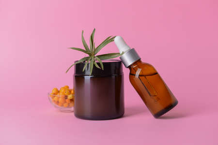 Healthy sea buckthorn cosmetics on color backgroundの写真素材