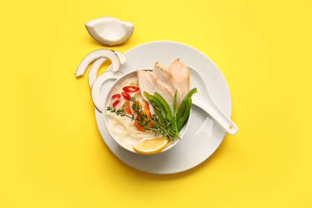 Bowl with Thai chicken noodle soup on color backgroundの写真素材