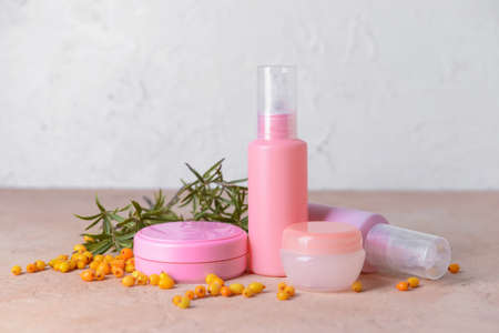 Healthy sea buckthorn cosmetics on grunge background