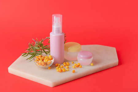 Healthy sea buckthorn cosmetics on color backgroundの写真素材