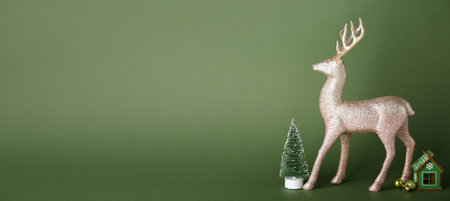 Reindeer with Christmas decor on green background with space for textの写真素材