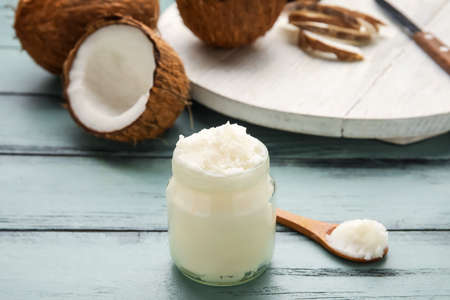 Jar with coconut oil on wooden backgroundの写真素材