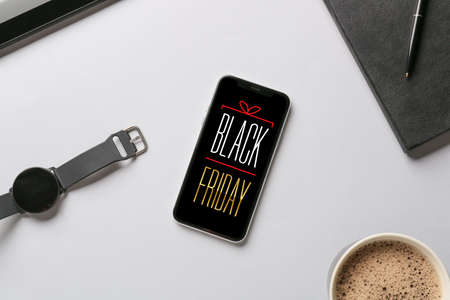 Text BLACK FRIDAY on screen of mobile phoneの写真素材