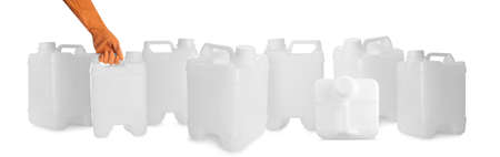 Hand with plastic jerrycans on white background