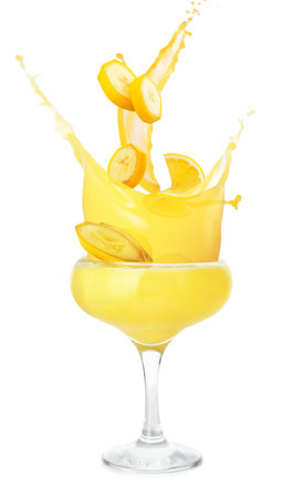 Glass of tasty banana daiquiri cocktail with splashes on white backgroundの写真素材