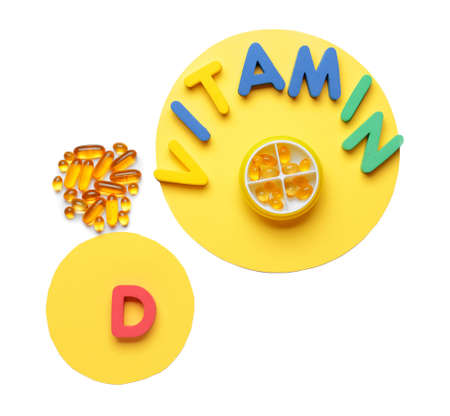 Text VITAMIN D with pills on white backgroundの写真素材