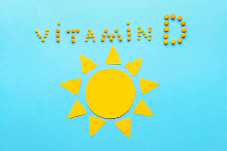 Text VITAMIN D with sun on color backgroundの写真素材