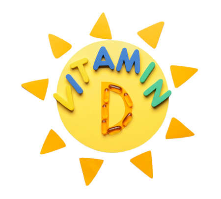 Text VITAMIN D with sun on white backgroundの写真素材