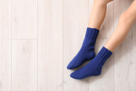 Legs of young woman in socks on wooden backgroundの写真素材