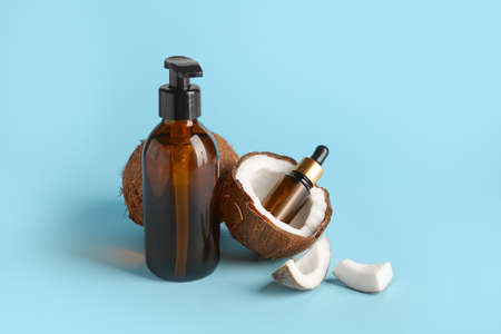 Bottles with coconut oil on color backgroundの写真素材