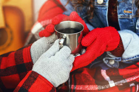 Young couple with mug of hot tea outdoors, closeupの写真素材