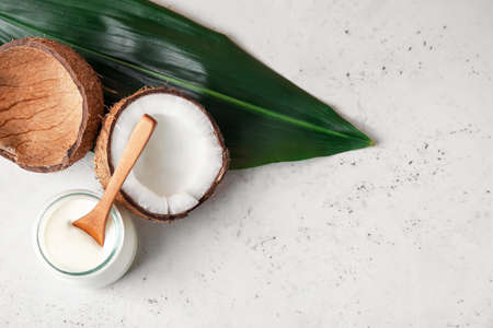 Jar with tasty coconut yogurt on light backgroundの写真素材