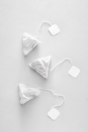 Tea bags on light background