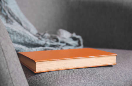 Old book on sofa, closeupの写真素材