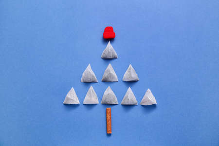 Christmas tree made of tea bags on color backgroundの写真素材