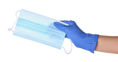 Female hand in protective glove with medical mask on white backgroundの写真素材