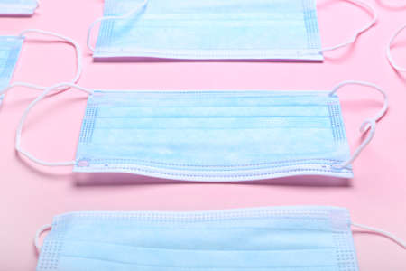 Medical masks on color background
