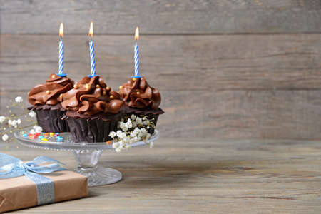 Composition with tasty chocolate cupcakes on wooden backgroundの写真素材