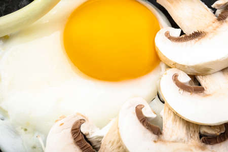 Frying pan with tasty egg, mushrooms and onion, closeupの写真素材
