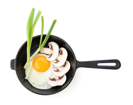 Frying pan with tasty egg, mushrooms and onion on white backgroundの写真素材