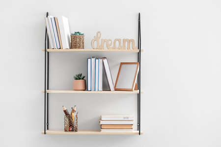 Stylish shelf hanging on light wallの写真素材