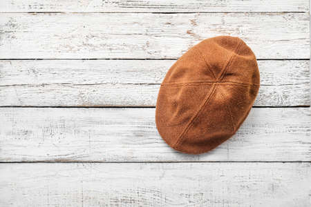 Stylish cap on light wooden backgroundの写真素材