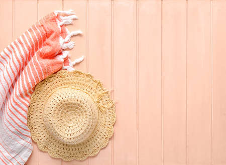 Stylish hat and handkerchief on color wooden backgroundの写真素材