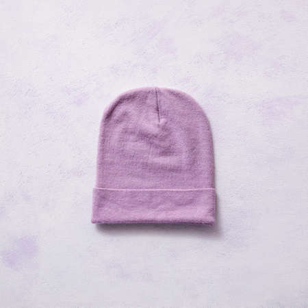 Stylish warm hat on color backgroundの写真素材