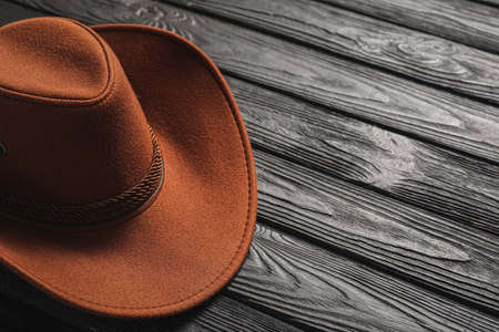 Stylish cowboy hat on dark wooden background, closeupの写真素材