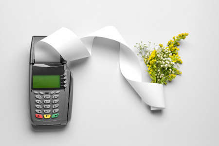 Payment terminal with flowers on light backgroundの写真素材