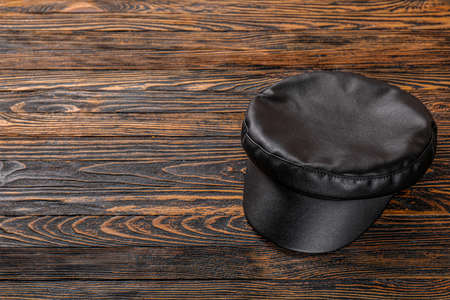 Stylish cap on wooden backgroundの写真素材