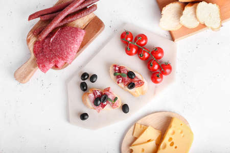 Tasty sandwiches with salami on light backgroundの写真素材