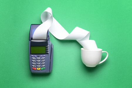 Payment terminal with cup on color backgroundの写真素材