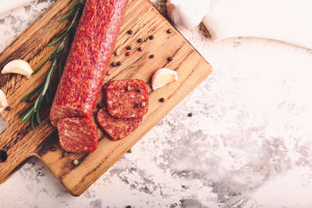 Composition with tasty salami and spices on grunge backgroundの写真素材