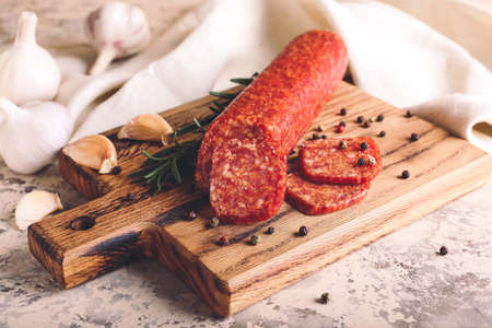Tasty salami with spices on grunge backgroundの写真素材