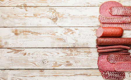 Tasty sausages on wooden background