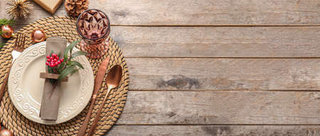 Beautiful Christmas table setting on wooden background with space for textの写真素材