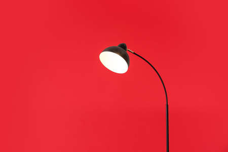 Stylish floor lamp on color background