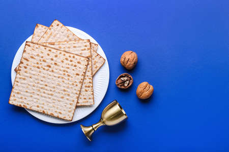 Composition with Jewish flatbread matza for Passover on color background