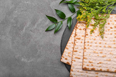 Jewish flatbread matza for Passover on gray backgroundの写真素材