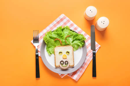 Plate with tasty sandwich in shape of bull on color backgroundの写真素材