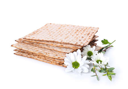 Jewish flatbread matza for Passover and flowers on white backgroundの写真素材